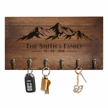 Personalized walnut key hanger engraved with The Smith’s Family, a date and a mountain design