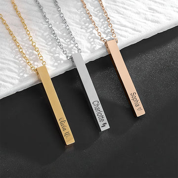 Three vertical bar necklaces in gold, silver and rose-gold finishes engraved with the names Olivia, Charlotte and Sophia.