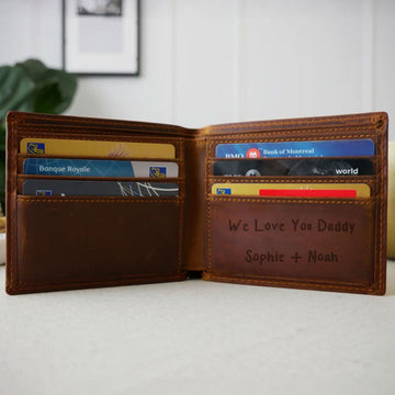 Open brown leather wallet with cards and a handwritten family message engraved inside