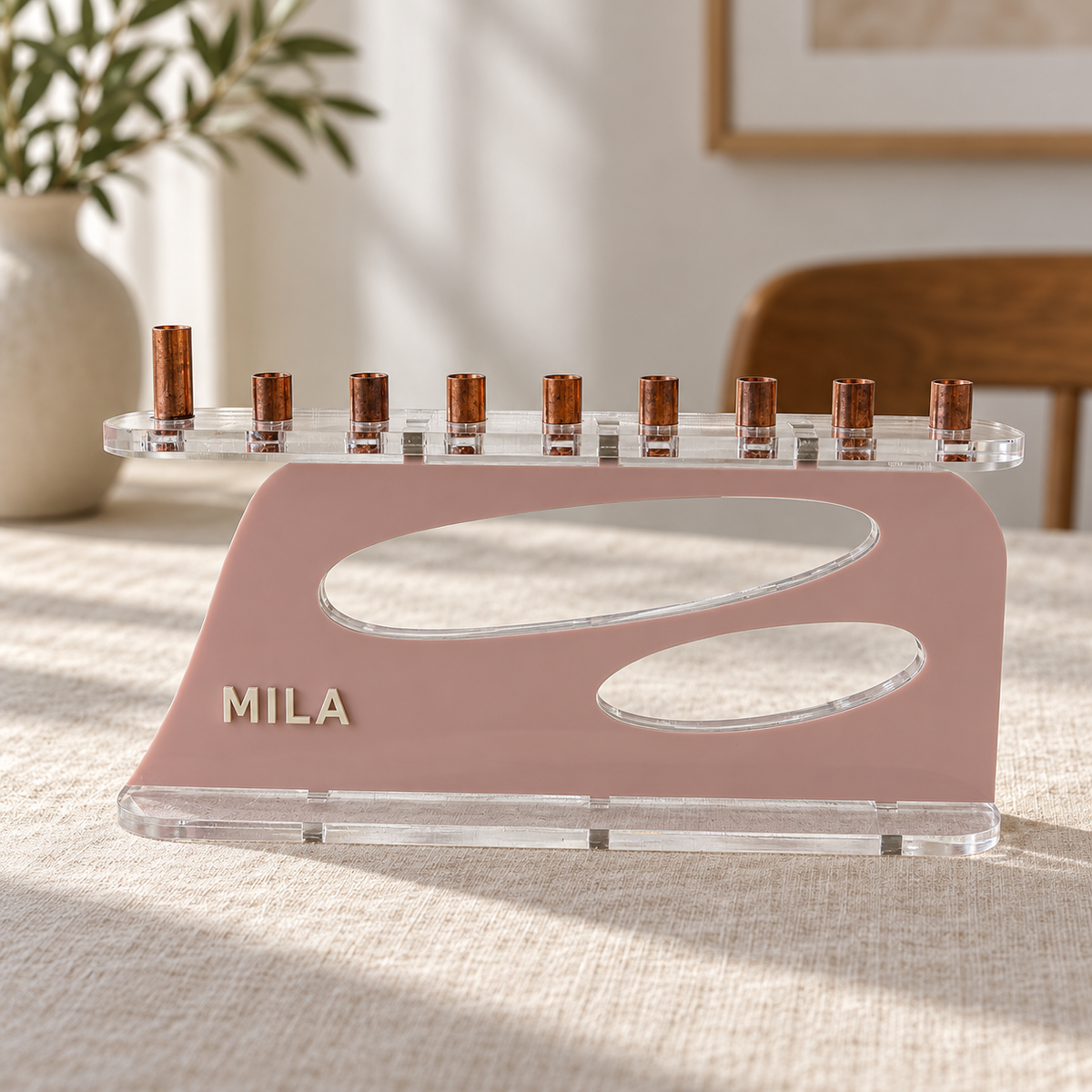 The Aperture personalized acrylic menorah in Mauve Berry and Eggshell, with MILA lettering, two oval openings, clear base and copper candle cups