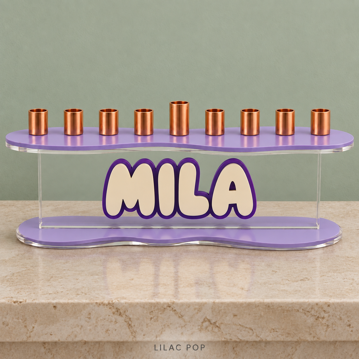 MILA acrylic menorah in Lilac Pop, with Lavender curved plates, Eggshell letters and a Purple outline against a sage wall
