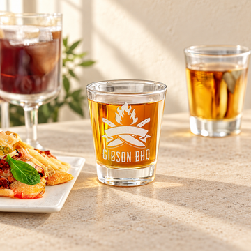 Engraved Shot Glass - "Custom Logo" — engraved detail, styled in natural daylight