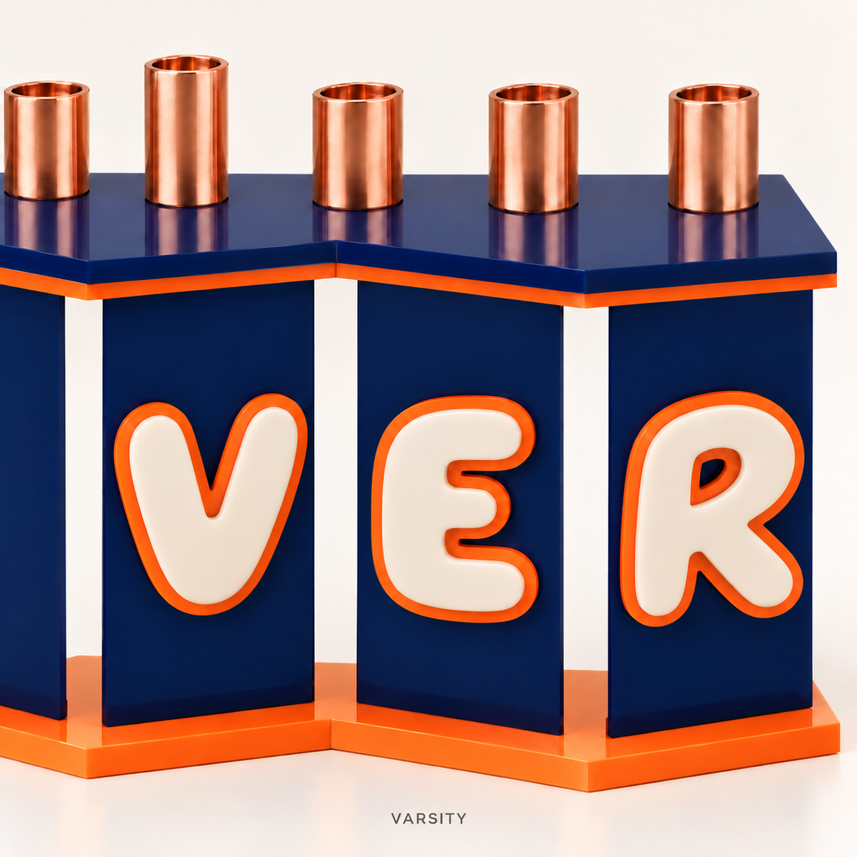 Close-up of The Fold menorah in Varsity showing raised cream acrylic letters, orange outlines, navy angled panels and copper candle cups.