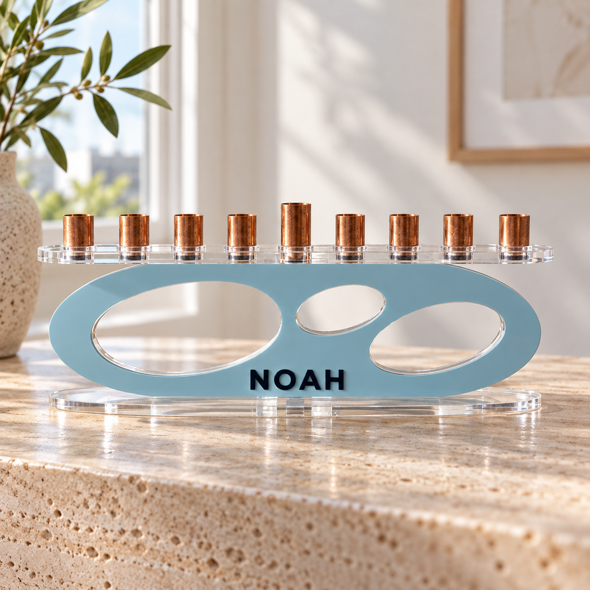 NOAH personalized Forma menorah in Ice with Navy lettering, clear oval base and copper candle cups