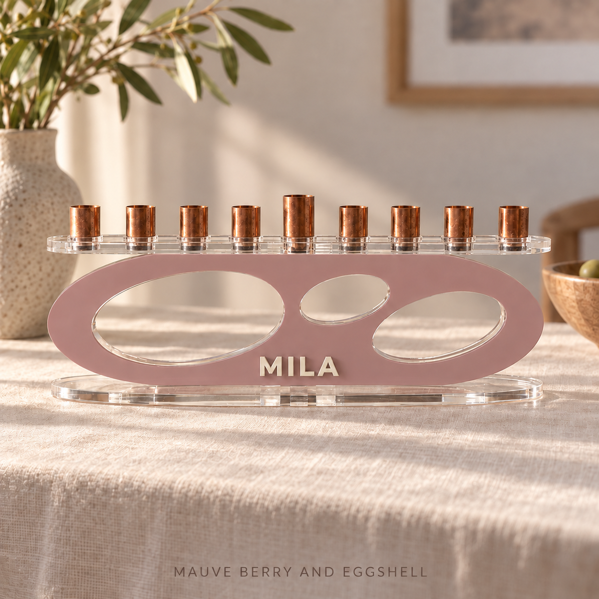 MILA personalized Forma menorah in Mauve Berry and Eggshell, with clear acrylic top and base on a linen-covered table