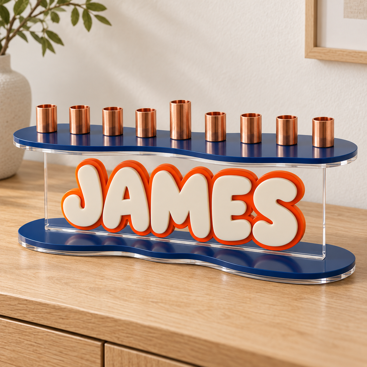 Angled view of JAMES menorah with navy curved plates and orange outlined cream name