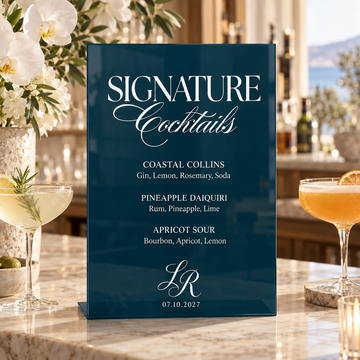 Dusk acrylic signature cocktail bar sign displayed with flowers and drinks on a wedding bar