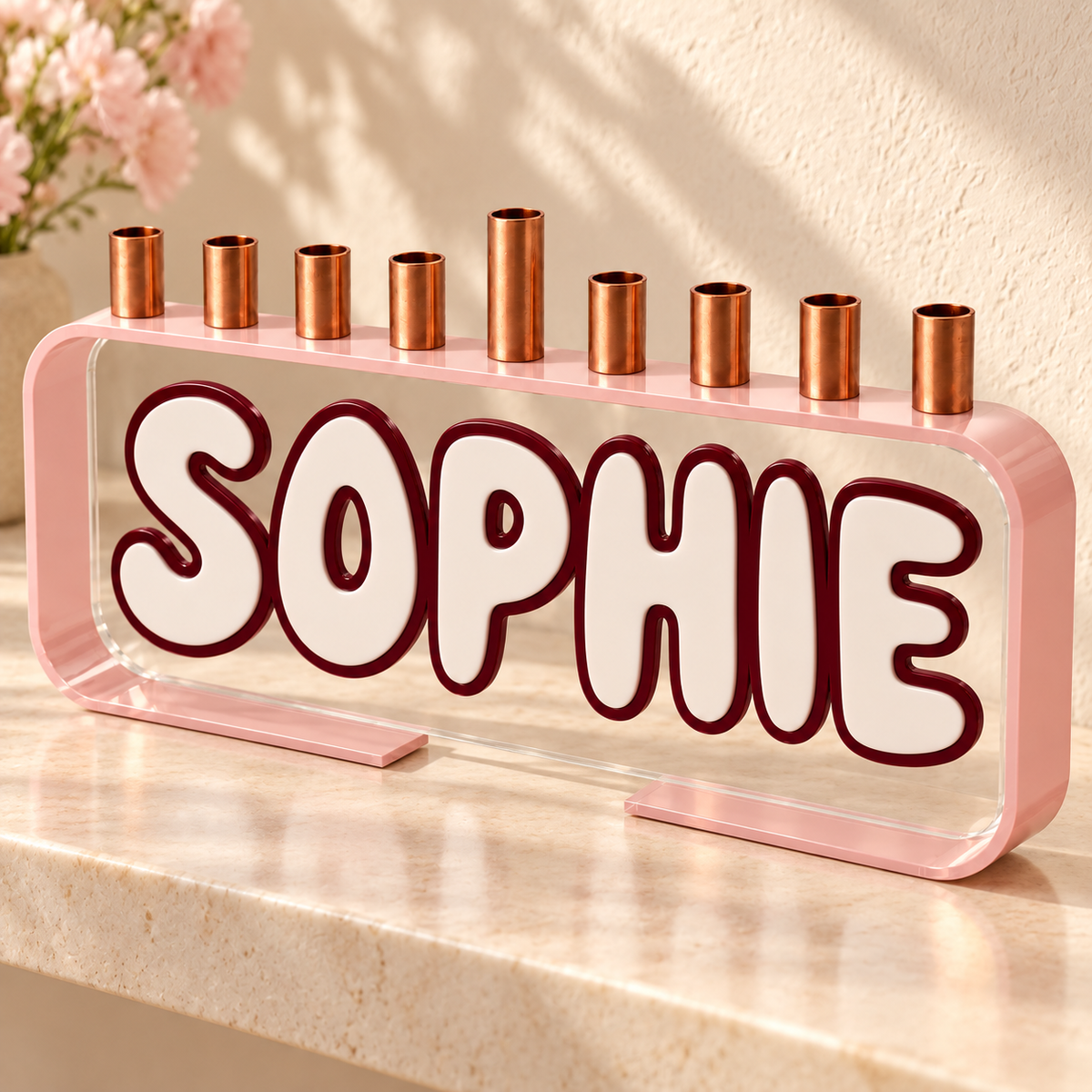 SOPHIE Loop menorah with pink frame and white lettering with burgundy outline