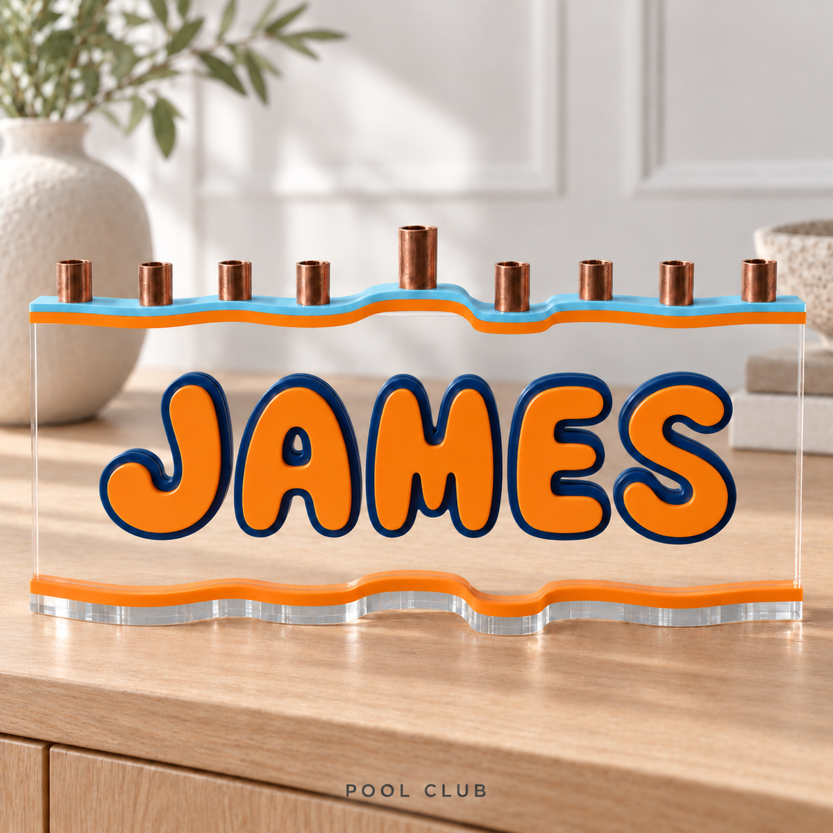 JAMES custom acrylic menorah in Pool Club, with Bluebell light sky blue top, Orange letters and matching base, Navy deep blue outlines and clear acrylic.