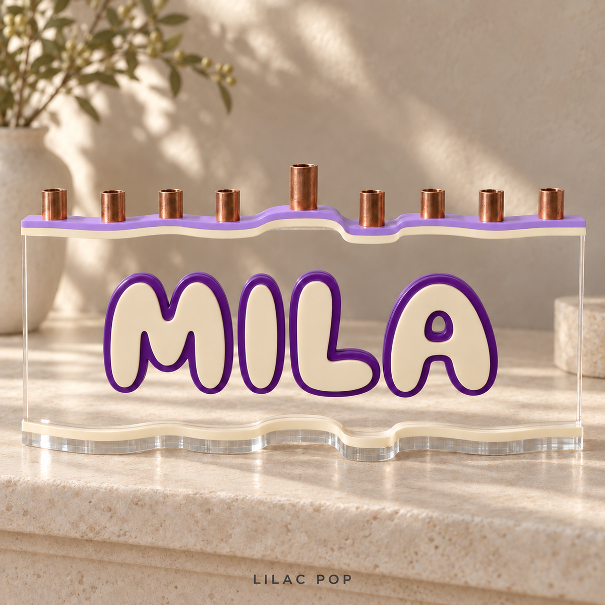 MILA custom acrylic menorah in Lilac Pop, with Lavender opaque lilac top, Eggshell warm cream letters and matching base, Purple deep violet outlines and clear acrylic.