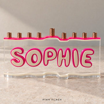 SOPHIE personalized acrylic menorah in Pink Flash, with a Neon Pink wave top, Eggshell letters and base, Fuchsia outlines and clear acrylic.